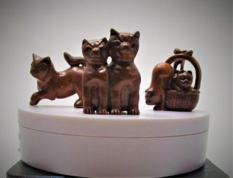 Three different wooden cat statues